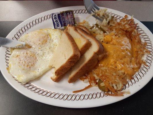 Smothered eggs with cheese, grilled onions & peppers.  Eggs with toast.