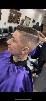 High fade with a styled comb over