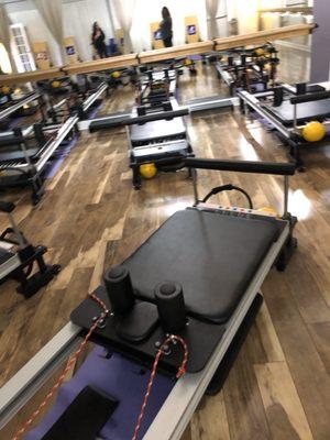 Inside Pilates studio w/ reformer machines