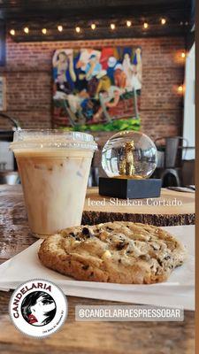 A cookies and creme cookie with an iced shaken  cortado.