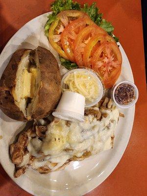 Chicken monterey with baked potato and sliced tomatoes