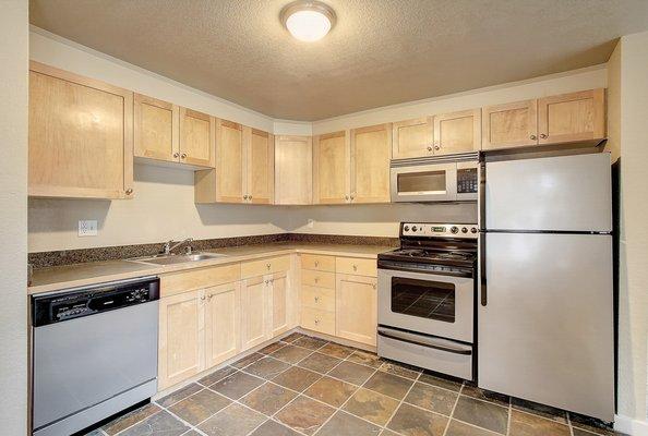 Open kitchen with tiled floors.