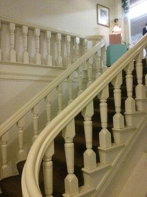 Beautiful old winding staircase leading from 2nd to 3rd floor. Wish they hadn't  painted the wood