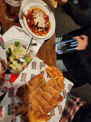 Baked spaghetti, antipasto salad, and bread