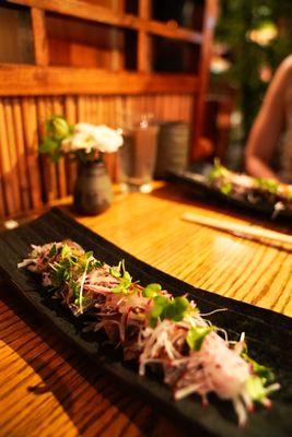 Katsuo Tataki (skipjack tuna) is overall light with slight tanginess and crunch from the shredded onions and radish.