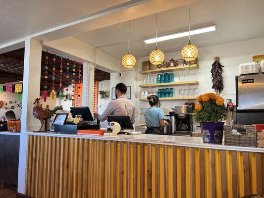 Front counter, cute coffee cups.