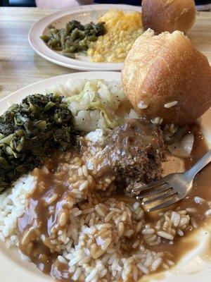 Hamburger steak, greens, cabbage, and rice with brown gravy and a roll, then enchilada casserole, creamed corn, greens, and green beans.