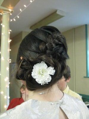 My cousin's updo wove into a flower at the bottom, but it's covered by another flower. It's beautiful both ways.