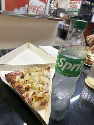 Slice of Hawaiian pizza plus a bottled soft drink for scale reference (I did already take one bite into my pizza LOL)