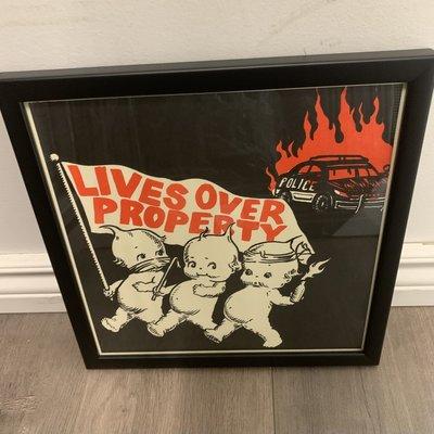 Lives over property print with a black frame and regular glass