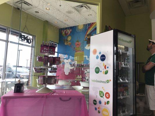 Bright seating area & a freezer displaying their premade ready to take home items