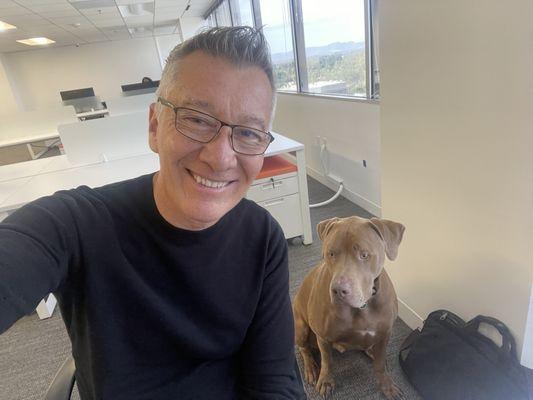 Picture of me with my new haircut and one of my coworkers dog.