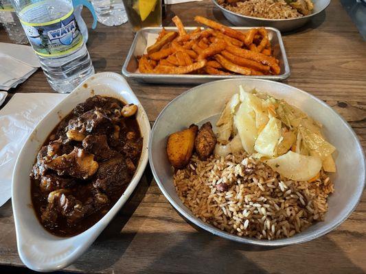 Uptown (ox tail with cooked cabbage and rice and peas)