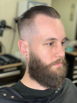 Skin fade slick back by Dapper Dan