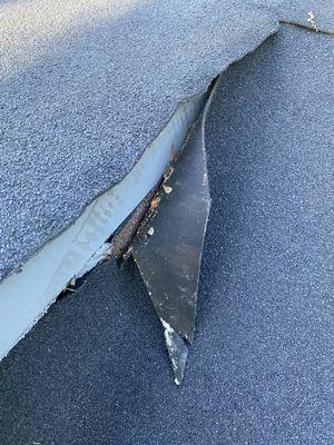 This part of the roof looks like it may have been cut with blunt scissors and pieces are already coming off, exposing gaps.