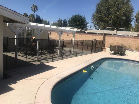 4' tall all black pool Fence with an arch top self-closing, self-latching gate installed in Woodland Hills.