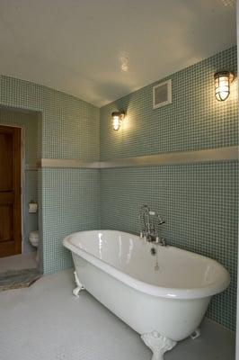 A barreled ceiling with aluminum accents make this room a beautiful place for a bath.