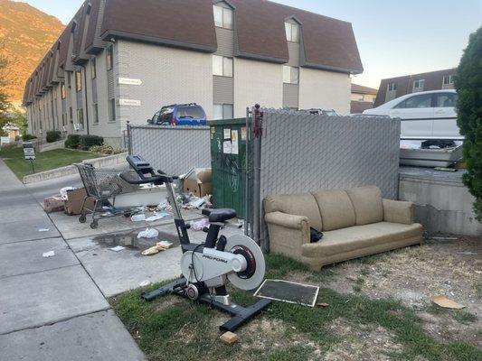 Another overflowing dumpster and trash everywhere