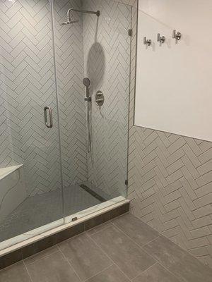 Herringbone walking shower and herringbone wainscoting.