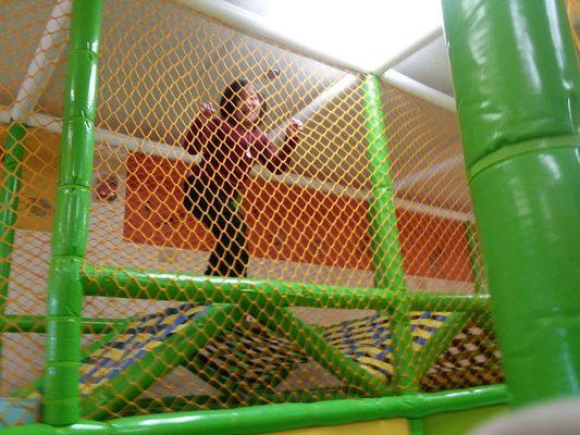 Going through a foam obstacle inside the indoor playground.