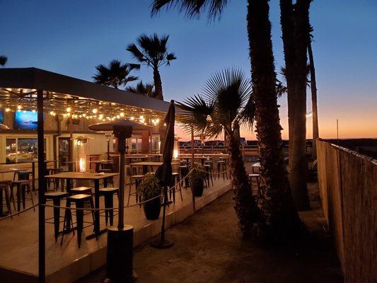 outdoor patio with ocean and sunset views.