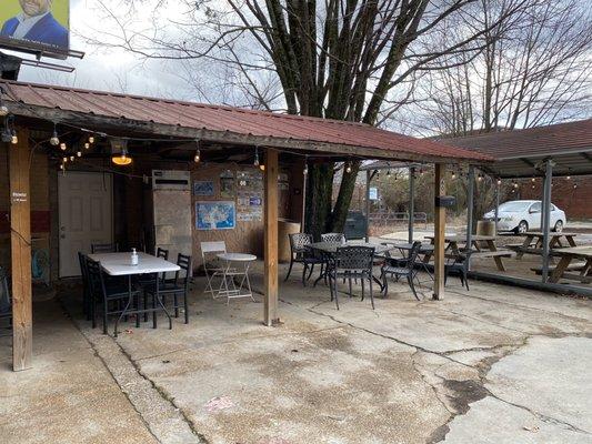 Outdoor seating and small parking area.