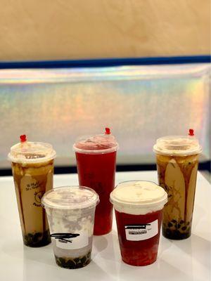 brown sugar boba milk teas, raspberry hibiscus tea w lychee boba, taro slushied &creamed w pearls boba, and raspberry & cream w lychee boba