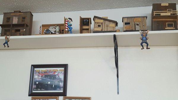 The Cowboys hanging from the shelf and leaning against the barber pole are hand carved!