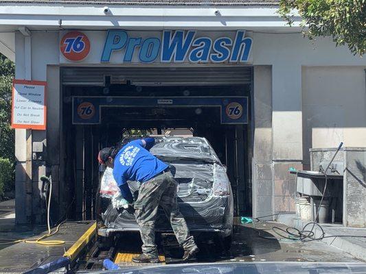 Hand wash (machine rinse, but none of those rubber whirling things that can scratch your car).