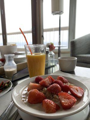 Room service breakfast oatmeal with berries and orange juice