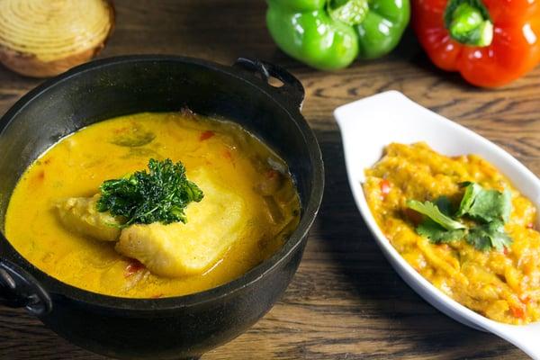 Muqueca de peixe com pirão. A classic Brazilian fish stew made with dende oil, green herbs, onions, tomatoes and coconut milk.