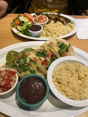 Foreground: chorizo taco and shrimp tacos. Background: mixed fajitas