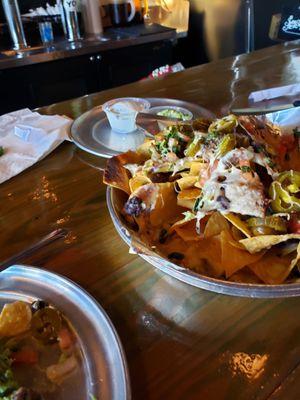 Steak nachos w/ guacamole and sour cream on the side.