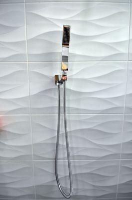 Hand held shower head over 3D tile