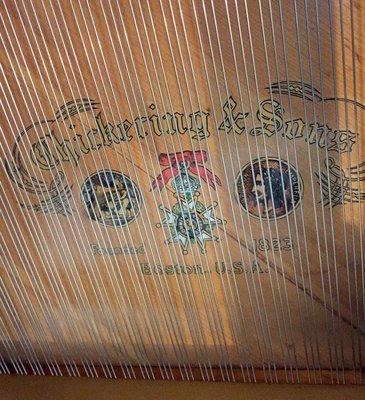 The split sound board on our beautiful antique baby grand piano.