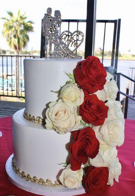 2 tiered Wedding Cake: First tier is Red Velvet & Second tier is Chocolate Caramel Crème Brûlée. Fresh Roses Red and White.