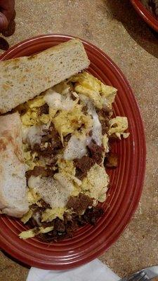 Steak and cheese scrambled eggs with homemade sourdough toast.