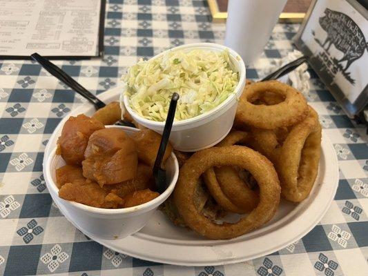 Platter with pulled pork, fried chicken, onion rings, yams, cole slaw