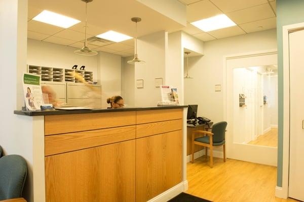 Our friendly staff at the reception desk, greeting you off the elevator.