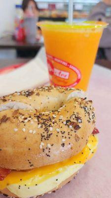 Freshly squeezed orange juice and everything bagel with bacon cheese and egg ....