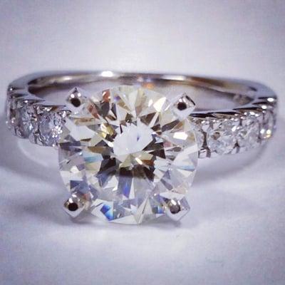 Stunning 2.34ct round brilliant cut diamond set in a 14k white gold setting accented with ten 0.06ct round diamonds.