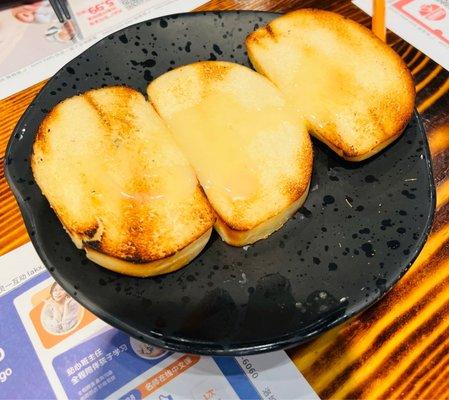 Toasted bun sliced with condensed milk.