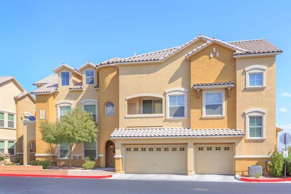 Southwest inspired property exterior with single and double garages.