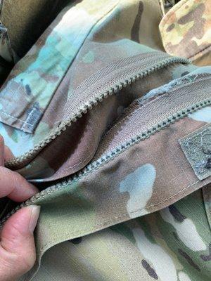 They Melted the  zipper to the uniform.