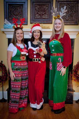 Cindy Rice, PTA, PRC; Tassie Cantrell, PT, CEO & President; Lizzy Oliver, PTA, pose for a photo in their festive outfits