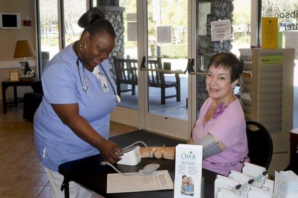 Our caregiver Rebecca helping us serve our local seniors through our monthly no-cost blood pressure clinics.