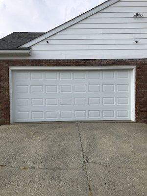 Simple but elegent white garage door, no windows.