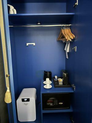 Armoire with coffee station, steamer, and a stocked fridge.