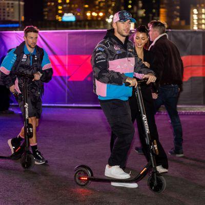 F1 driver Pierre Gasly on an Atomic scooter.