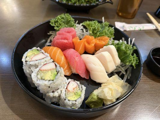 Sushi and sashimi lunch special. Seaweed salad in the background.